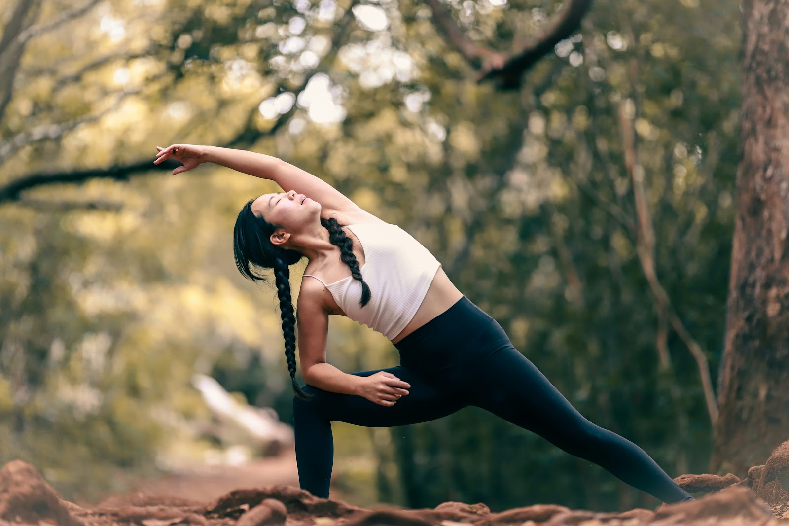 An image of a woman stretching in nature.