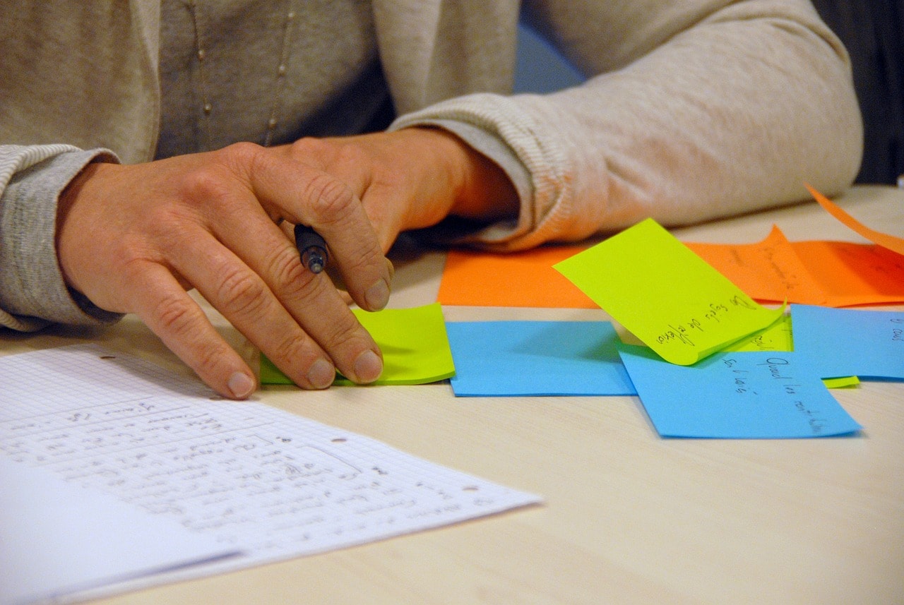 man with several sticky notes on the table